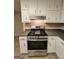 Kitchen featuring stainless steel oven/stove with white cabinets and dark countertops at 245 Kim Trl, Stockbridge, GA 30281