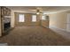 Bright and airy living room showcasing a stone fireplace, multiple windows, and easy access to other areas of the home at 245 Kim Trl, Stockbridge, GA 30281