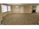 Spacious living room featuring neutral walls, carpeted flooring, large windows, and a brick fireplace at 245 Kim Trail, Stockbridge, GA 30281