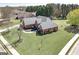 Lovely red brick home with manicured lawn, mature trees and an American flag at 1000 Maria Dr, Mcdonough, GA 30253