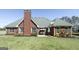 Inviting backyard with a brick home featuring a patio and a cozy swing for relaxing outdoors at 1000 Maria Dr, Mcdonough, GA 30253