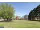 Large grassy backyard has mature trees and trampoline, perfect for outdoor activities and entertaining at 1000 Maria Dr, Mcdonough, GA 30253