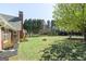 The lush backyard has a fire pit and mature trees, making it the perfect place for relaxing and entertaining at 1000 Maria Dr, Mcdonough, GA 30253