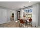 Bright breakfast nook with a round wooden table and modern chairs, bathed in natural light from a large window at 1000 Maria Dr, Mcdonough, GA 30253