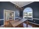 Stylish dining room featuring a large window, modern lighting, and views of the entry and living area at 1000 Maria Dr, Mcdonough, GA 30253