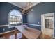 Elegant dining room with hardwood floors, a statement window, and modern light fixture at 1000 Maria Dr, Mcdonough, GA 30253