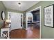 Inviting foyer with hardwood floors, neutral paint, and views of the dining room with accent wall at 1000 Maria Dr, Mcdonough, GA 30253
