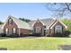 Beautiful brick home with a well-manicured lawn and mature landscaping at 1000 Maria Dr, Mcdonough, GA 30253