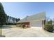 Exterior view of a two-car garage, large driveway, and well-maintained landscaping at 1000 Maria Dr, Mcdonough, GA 30253