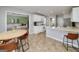 Bright kitchen featuring white cabinetry, stainless steel appliances, and an adjacent breakfast nook perfect for casual dining at 1000 Maria Dr, Mcdonough, GA 30253