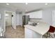 Modern kitchen with stainless steel appliances, white cabinets, and spacious countertop, creating an inviting cooking space at 1000 Maria Dr, Mcdonough, GA 30253