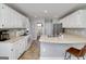 Well-lit kitchen with white cabinets, modern appliances, and ample counter space for cooking and entertaining at 1000 Maria Dr, Mcdonough, GA 30253