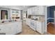 Bright kitchen with white cabinets, stainless appliances, and an open layout, adjacent to a cozy breakfast nook at 1000 Maria Dr, Mcdonough, GA 30253