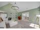 Open living space featuring high ceilings, modern lighting, and views into the dining and kitchen areas at 1000 Maria Dr, Mcdonough, GA 30253