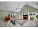 Cozy living room with a fireplace, vaulted ceiling, large windows, and plush neutral carpeting at 1000 Maria Dr, Mcdonough, GA 30253