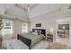 Serene main bedroom with a tray ceiling, chandelier, a comfortable bed, and ample natural light from the windows at 1000 Maria Dr, Mcdonough, GA 30253