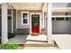 Inviting front porch with a bright red door and brick accents for added curb appeal at 14 Singleton Way, Peachtree City, GA 30269