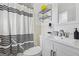 Well-lit bathroom featuring a shower with a black and white striped curtain, a modern vanity, and a toilet at 3216 Pheasant Dr, Decatur, GA 30034