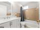 Bathroom featuring white sink and vanity, toilet and tub/shower combo with brown tile accent at 3216 Pheasant Dr, Decatur, GA 30034