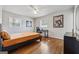 Bright bedroom featuring hardwood floors, two windows, and a modern-style study desk at 3216 Pheasant Dr, Decatur, GA 30034