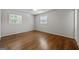 Empty bedroom featuring hardwood floors and two windows at 3216 Pheasant Dr, Decatur, GA 30034