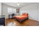 A cozy bedroom with hardwood floors features a modern desk, chair, and warm orange accents at 3216 Pheasant Dr, Decatur, GA 30034