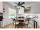 Charming dining area with hardwood floors, modern ceiling fan, and view to the living room at 3216 Pheasant Dr, Decatur, GA 30034