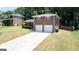 View of home, lawn and long driveway leading to a two-car garage on a sunny day at 3216 Pheasant Dr, Decatur, GA 30034