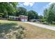 Landscape view of a cozy home on a well maintained street, with green lawn and long driveway at 3216 Pheasant Dr, Decatur, GA 30034