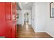 Welcoming foyer with hardwood floors, a red front door, neutral paint, and a view into the home at 3216 Pheasant Dr, Decatur, GA 30034