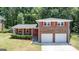 Charming brick home with vibrant red shutters, a welcoming front door, and a well-manicured lawn at 3216 Pheasant Dr, Decatur, GA 30034