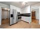 Bright kitchen with white cabinets, stainless steel refrigerator, and mosaic backsplash at 3216 Pheasant Dr, Decatur, GA 30034