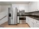 Stylish kitchen with white cabinets, stainless steel appliances, and laminate flooring at 3216 Pheasant Dr, Decatur, GA 30034