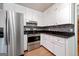 Modern kitchen featuring stainless steel appliances, white cabinets, and granite countertops at 3216 Pheasant Dr, Decatur, GA 30034