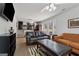 Comfortable living room featuring hardwood floors, an orange sofa, a leather sofa, and a black ottoman at 3216 Pheasant Dr, Decatur, GA 30034