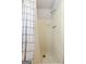 Tiled shower stall with white curtain featuring simple black dashes at 3216 Pheasant Dr, Decatur, GA 30034