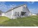 A backyard view with green grass, a covered patio, and gray siding on the house at 3201 Azteca Way, Dacula, GA 30019