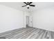 Spacious bedroom featuring modern ceiling fan, gray wood-look floors, and bright white walls at 3201 Azteca Way, Dacula, GA 30019