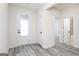 A bright foyer with gray wood-look flooring and white doors, offering a welcoming entrance at 3201 Azteca Way, Dacula, GA 30019