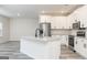 Kitchen view showcasing stainless steel appliances, white cabinets, and an island with granite countertops at 3121 Azteca Way, Dacula, GA 30019