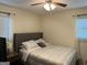 Cozy bedroom with a ceiling fan, neutral walls, and a comfortable upholstered bed at 5142 Rock Eagle Dr, Stone Mountain, GA 30083