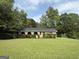 Unique brick home featuring arched entryways, a black roof, and a lush lawn at 5142 Rock Eagle Dr, Stone Mountain, GA 30083