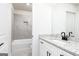 Modern bathroom featuring gray tiled shower, granite vanity top, and black hardware fixtures at 3754 Saddle Bag Ct, Dacula, GA 30019