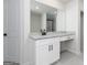 Bathroom vanity features granite countertop, white cabinets, modern fixtures, and a large mirror at 3754 Saddle Bag Ct, Dacula, GA 30019