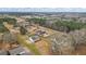 Property aerial view with expansive lot, vintage airplane, and nearby houses at 3403 Bill Gardner Pkwy, Locust Grove, GA 30248