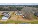 Wide aerial view of the property showing the house, airplane, large lot, and surrounding neighborhood at 3403 Bill Gardner Pkwy, Locust Grove, GA 30248