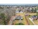 Aerial view of a property nestled among trees with surrounding homes and outbuildings at 3403 Bill Gardner Pkwy, Locust Grove, GA 30248