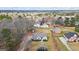 Aerial view of a home nestled among trees in a quiet neighborhood, showcasing its large lot at 3403 Bill Gardner Pkwy, Locust Grove, GA 30248