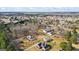 Wide aerial shot showcasing the property's setting within a sprawling neighborhood and wooded landscape at 3403 Bill Gardner Pkwy, Locust Grove, GA 30248