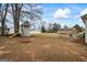 Large backyard featuring a playhouse and a fire pit, perfect for outdoor fun and entertaining at 3403 Bill Gardner Pkwy, Locust Grove, GA 30248